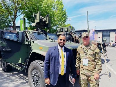 Alexandre Benalla alongside U.S. military personnel and armored vehicles